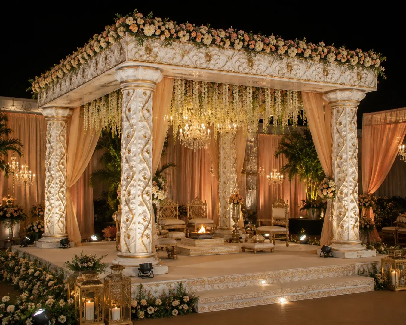 Fiber wedding mandap with floral decor and draped curtains on a raised stage